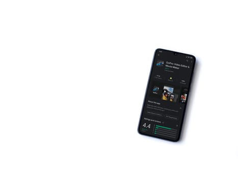 Lod, Israel - July 8, 2020: GoPro - Video Editor & Movie Maker app play store page on the display of a black mobile smartphone isolated on white background. Top view flat lay with copy space.