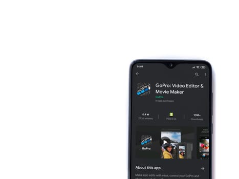 Lod, Israel - July 8, 2020: GoPro - Video Editor & Movie Maker app play store page on the display of a black mobile smartphone isolated on white background. Top view flat lay with copy space.
