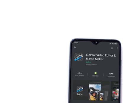 Lod, Israel - July 8, 2020: GoPro - Video Editor & Movie Maker app play store page on the display of a black mobile smartphone isolated on white background. Top view flat lay with copy space.
