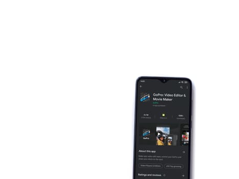 Lod, Israel - July 8, 2020: GoPro - Video Editor & Movie Maker app play store page on the display of a black mobile smartphone isolated on white background. Top view flat lay with copy space.
