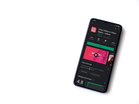 Lod, Israel - July 8, 2020: InShot - Video Editor & Movie Maker app play store page on the display of a black mobile smartphone isolated on white background. Top view flat lay with copy space.