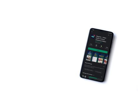 Lod, Israel - July 8, 2020: Magisto - Video Editor & Movie Maker app play store page on the display of a black mobile smartphone isolated on white background. Top view flat lay with copy space.