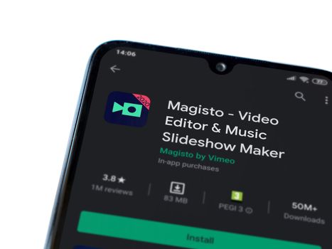 Lod, Israel - July 8, 2020: Magisto - Video Editor & Movie Maker app play store page on the display of a black mobile smartphone isolated on white background. Top view flat lay with copy space.