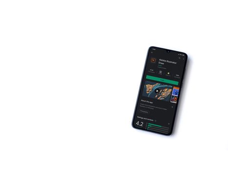 Lod, Israel - July 8, 2020: Adobe Illustrator Draw app play store page on the display of a black mobile smartphone isolated on white background. Top view flat lay with copy space.