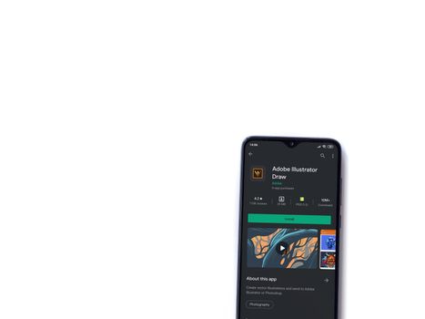 Lod, Israel - July 8, 2020: Adobe Illustrator Draw app play store page on the display of a black mobile smartphone isolated on white background. Top view flat lay with copy space.