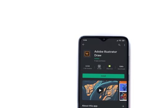 Lod, Israel - July 8, 2020: Adobe Illustrator Draw app play store page on the display of a black mobile smartphone isolated on white background. Top view flat lay with copy space.