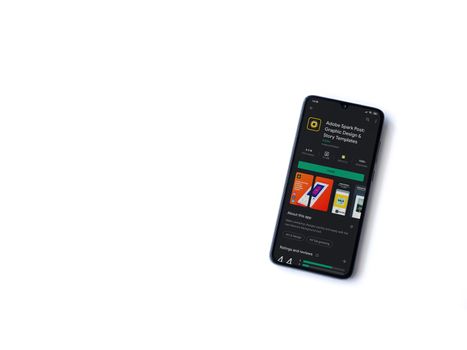 Lod, Israel - July 8, 2020: Adobe Spark Post - Graphic Design & Story Templates app play store page on the display of a black mobile smartphone on white background. Top view flat lay with copy space. 