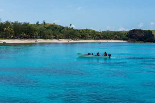 Fiji, South Pacific -- February 7, 2016. A small motorboat slowly makes its way into shore.