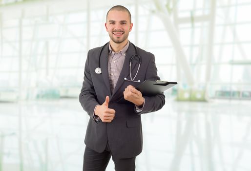 happy male doctor going thumb up, at the hospital