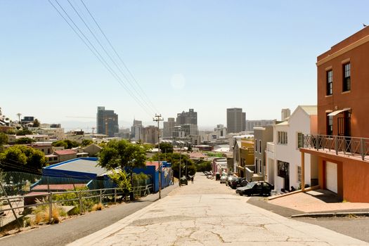 Colorful houses in the Bo Kaap district with cityscape in Cape Town, South Africa.