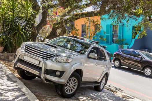 Silver off-road vehicle Jeep SUV in the Bo-Kaap district, Cape Town, South Africa.
