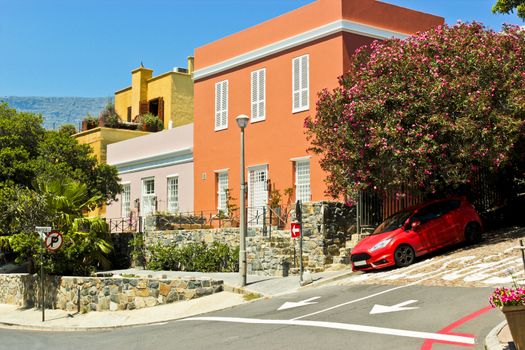 Red slanted sports car in the Bo-Kaap district, Cape Town, South Africa.