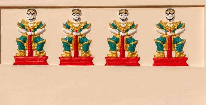 Penang, Malaysia -- March 7, 2016. Photo of four statues carved into a wall of an ancient pagoda in Penang Malaysia.