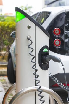 Electric car charging station at street level in Singapore, Southeast Asia.