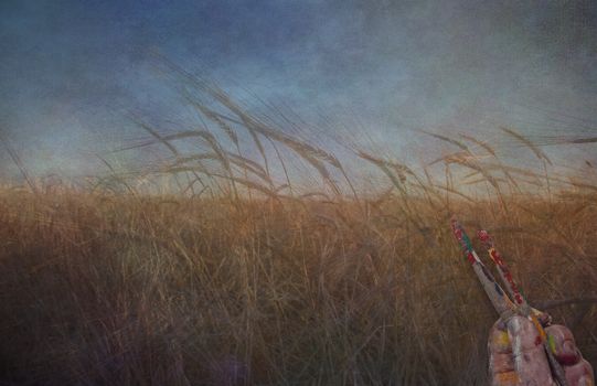 Painters hand and brushes over grunge landscape
