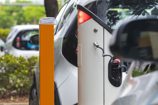 Electric car charging station at street level in Singapore, Southeast Asia.