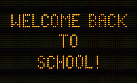 A Traffic Sign Saying Welcome Back To School For The New Semester