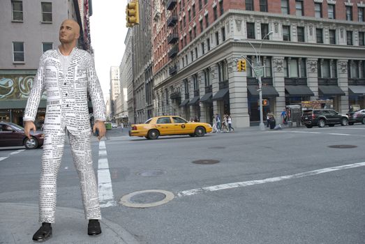 Surrealism. Man in suit  made of newspaper is standing on street of New York.