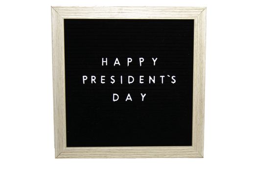 A Black Sign With a Birch Frame That Says Happy Presidents Day in White Letters on a Pure White Background