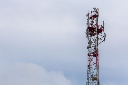 3G, 4G, 5G, wireless and cell phone telecommunication tower close-up on cloudy daylight sky background, horizontal shot with copy space