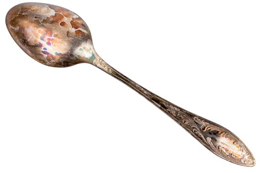 German silver or cupronickel spoon with visible oxidation layer isolated on white baclground.