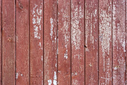 peeling white paint over brown paint on vertical planks flat wooden board background and texture.