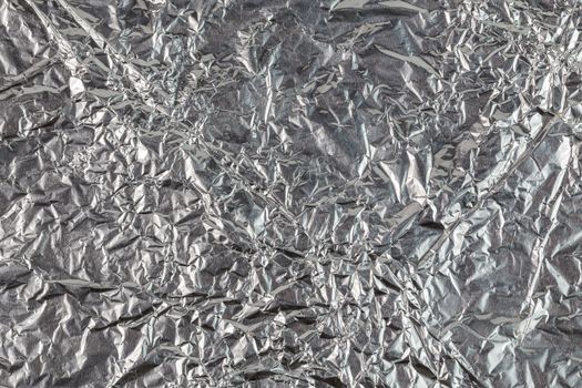 crumpled aluminium foil flat background and texture.