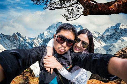 Young Couple in sunglasses Tourists on Hight snow mountain in China