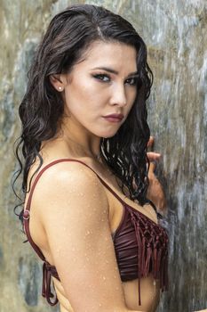 A gorgeous brunette model enjoys a day at the pool on a Caribbean island