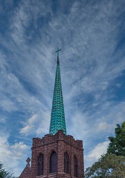 Old Bell Tower and Green Steeple of an Old Stone Church
