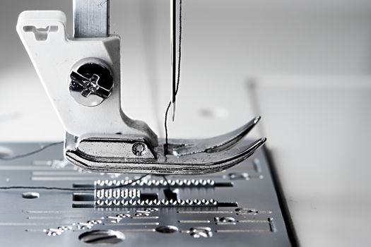 5 - Macro sewing machine side view with flat foot plate ready to stitch.
