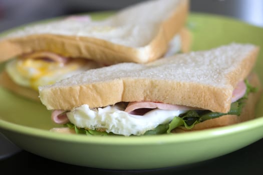 Close up of ham, bread, vegetables and cheese for simple and delicious homemade sandwich.