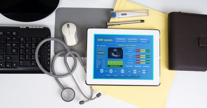 Top view of medical record system show patient information on digital tablet on working desk.