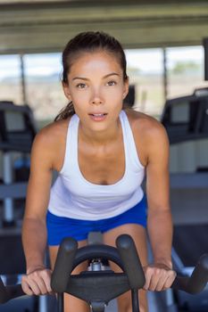 Woman doing interval training on indoor bike.