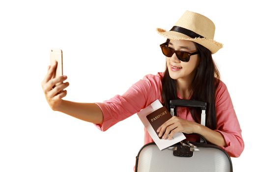 Beautiful asian woman cheerful smiling and take selfie on smart mobile phone, beauty young girl wear hat enjoy and fun in vacation isolated on white background, holiday concept. 