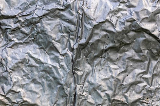 crumpled thick aluminium foil wall insulation surface texture and background.