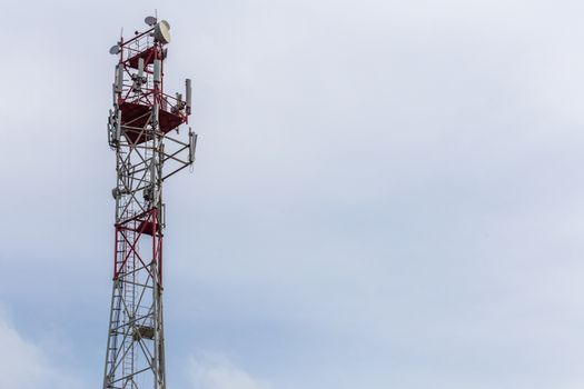 3G, 4G, 5G, wireless and cell phone telecommunication tower close-up on cloudy daylight sky background, horizontal shot with copy space