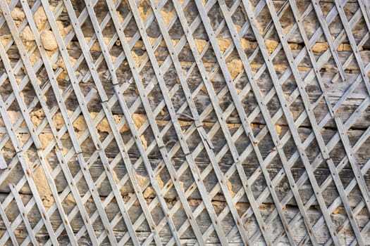 wattle and daub wall texture and background under direct sunlight at daytime.