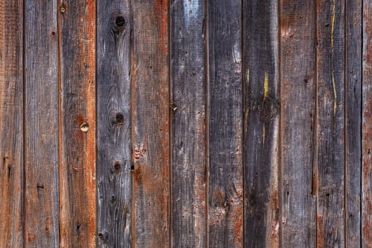 artistic texture of an old wooden planks fence in black and brown tones - close-up rustic background