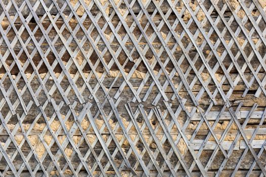 wattle and daub wall texture and background under direct sunlight at daytime.