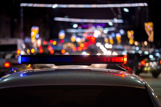 night police car lights in city - close-up with selective focus and bokeh background blur