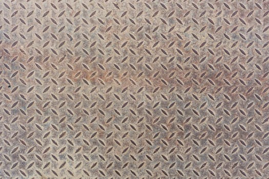 Grey dusty flat heavy metal sheet floor texture with diamond or checker or tread skid proof pattern. Background and texture.