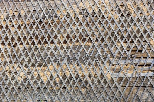 wattle and daub wall texture and background under direct sunlight at daytime.