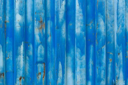 outside wall of old blue iso freight container - background and texture.