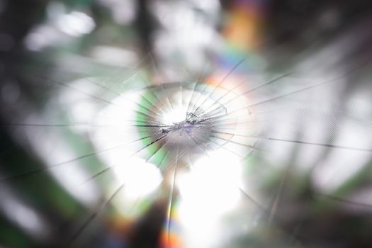 abstract background of broken tft lcd with localized radial cracks from one hit - close-up with selective focus and background blur