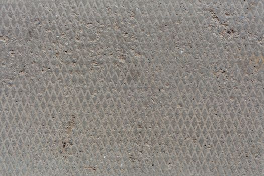 seamless old flat and dry concrete texture with diamond pattern and light signs of erosion.