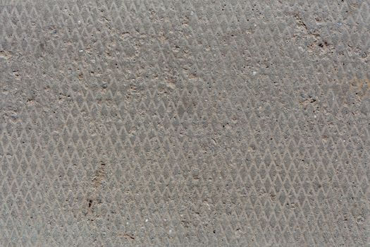 seamless old flat and dry concrete texture with diamond pattern and light signs of erosion.