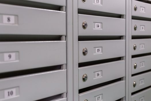 gray mailboxes on the landing of small russian condominium