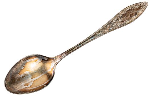 old cupronickel spoon with visible oxidation layer isolated on white background in flat lay perspective