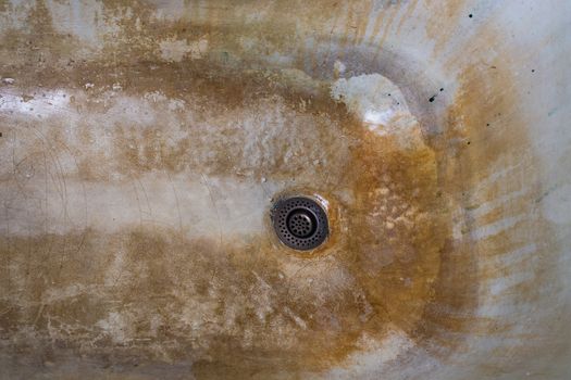 old rusted and stained cast iron bathtub close-up.